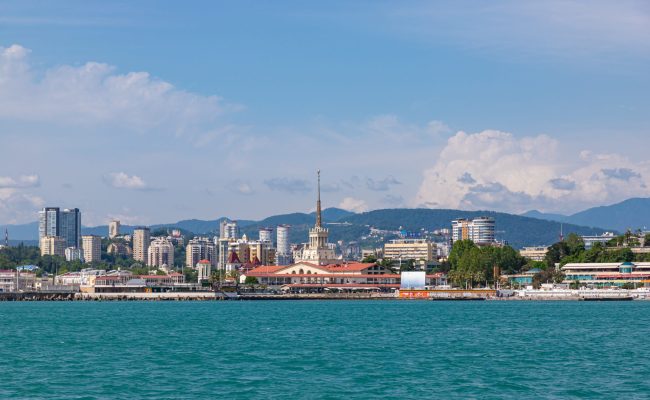 Sochi city coast panorama at summer. View from yacht. Black sea, Russia.